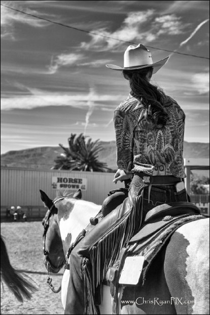 Cowgirl on horse during horse competition at rodeo (ChrisRyanPIX)