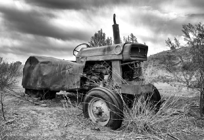 Photo of old vintage farm tractor in black and white